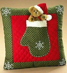 a teddy bear in a christmas stocking on a pillow