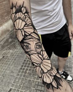 a man with a flower tattoo on his arm