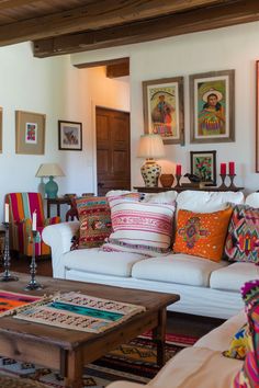 a living room filled with lots of colorful pillows