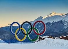 the olympic rings are in front of snowy mountains