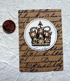 a penny sitting on top of a table next to a piece of paper with writing