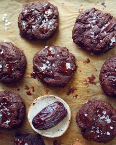 chocolate cookies with sea salt on top and one cookie in the middle next to it