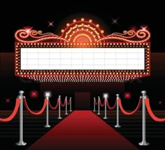 a red carpet with barriers and roped off gates at the entrance to a movie theater