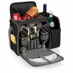 an open lunch bag with utensils and wine bottles in the compartment, on a white background