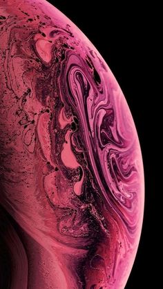 the back side of an iphone with pink and purple swirls on it's surface