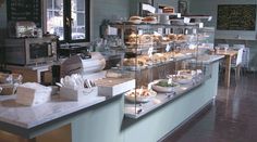 there are many different foods on the counter in this store that is open for business