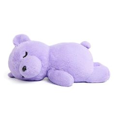 a purple teddy bear laying down on the ground