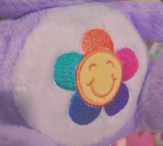 a close up of a stuffed animal with a smiley face on it's back