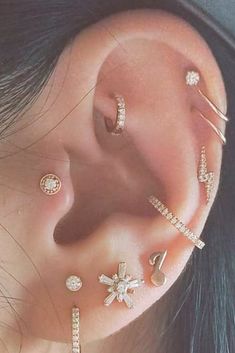 a woman with multiple piercings on her ear