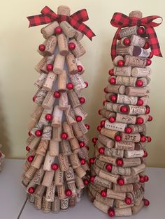 two wine cork christmas trees made to look like they are stacked on top of each other