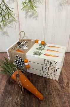 a carrot sitting next to a box with farm fresh carrots on it