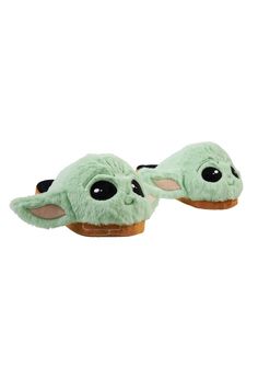 the child's slippers are green with black eyes