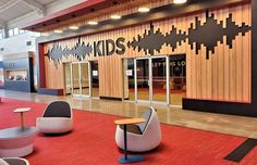 the inside of a children's store with chairs and tables in front of it