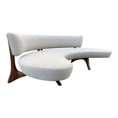 an upholstered lounge chair and ottoman in white fabric with walnut legs, designed by george nelson for knoll