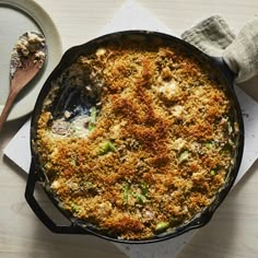 a casserole dish with broccoli and cheese in it on a table