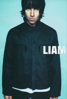 a man standing in front of a blue wall with the words llam on it