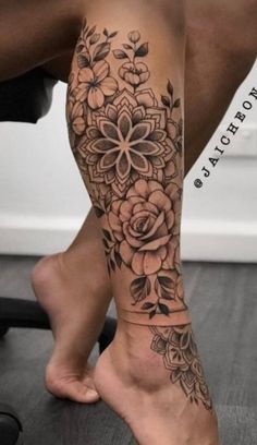 a woman's leg with flowers on it