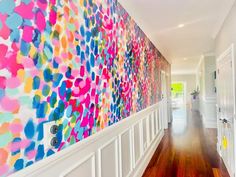 the hallway is decorated with brightly colored wallpaper