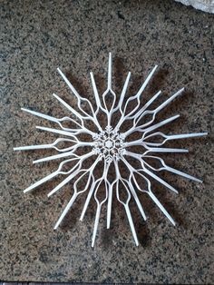 a clock made out of toothpicks sitting on top of a granite countertop