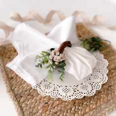 napkins with flowers on them are sitting on a doily that sits on a table