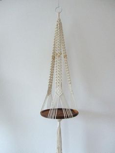 a white macrame hanging from the ceiling