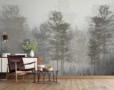 a living room with a large wall mural and wooden floors