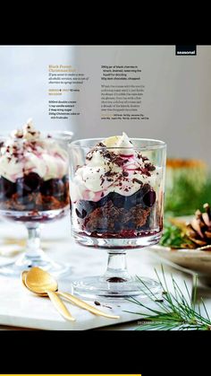 two desserts in glasses on a table with pine cones