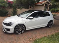 a white car parked in front of a house