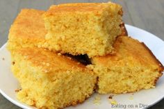 three pieces of cornbread on a white plate