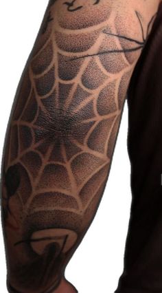 a man with a spider web tattoo on his arm