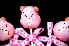 three pink teddy bears with polka dots on them and one has a bow around its neck