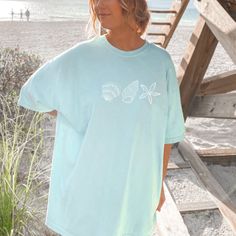 This t-shirt is everything you've dreamed of and more. It feels soft and lightweight, with the right amount of stretch.  It's the perfect beach vacation tee.  Wear is as a coverup over your swimsuit or pair it with some summer shorts.   For an oversized look, size up 1-3 sizes. * 100% combed and ring-spun cotton (Heather colors contain polyester) * Fabric weight: 4.2 oz/yd² (142 g/m²) * Pre-shrunk fabric * Side-seamed construction * Shoulder-to-shoulder taping * Blank product sourced from Guatemala, Nicaragua, Mexico, Honduras, or the US Casual Ocean Color Crew Neck T-shirt, Beachy Relaxed Fit Short Sleeve T-shirt, Relaxed Fit Short Sleeve T-shirt For Beach Season, Beachy Oversized Short Sleeve Tops, Oversized Beachy Crew Neck Tops, Oversized Blue T-shirt For Beach Season, Oversized Blue T-shirt For The Beach, Oversized Crew Neck T-shirt For Beach, Beachy Oversized Graphic Print T-shirt