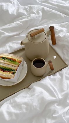 a tray with a sandwich and cup of coffee on it