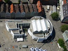 an aerial view of a building with soccer balls on the ground