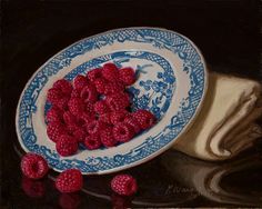 a painting of raspberries in a blue and white bowl on a black background