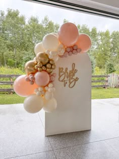 balloons and streamers decorate the entrance to a bridal party