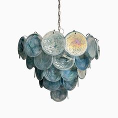 a chandelier made out of glass plates hanging from a chain