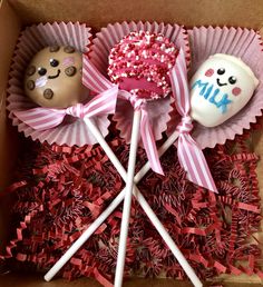 two lollipops in a box with pink bows