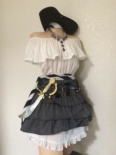 a mannequin wearing a skirt and hat with scissors on it's waist