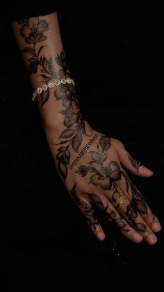 a woman's hand with tattoos on it