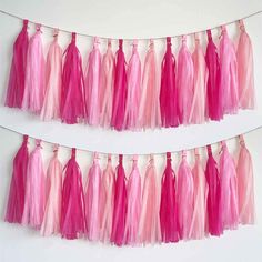 pink and red tissue tassels hanging on the wall