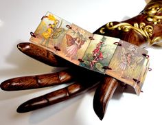 an old pair of wooden scissors with pictures on them