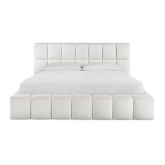 the bed is made with white linens and has an upholstered headboard