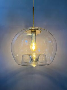 a clear glass light fixture hanging from a ceiling