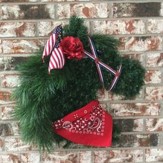 a christmas stocking hanging on a brick wall with an american flag and red bandanna