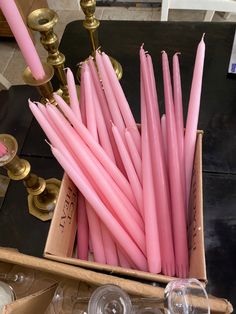 pink candles are in a box on a table