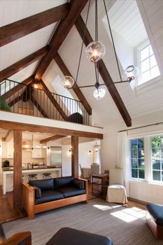 a living room filled with furniture next to a kitchen