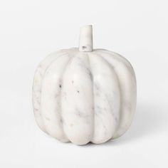 a white marble pumpkin sitting on top of a table