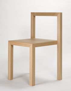 a wooden chair sitting on top of a white floor