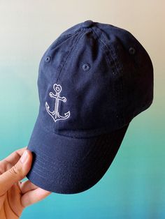 Anchors Away! This custom embroidered baseball hat has the Anchor24 logo complete with a heart at the top. Details: -Navy hat with white embroidery -1 size fits all with adjustable strap -100% brushed cotton -Machine washable Follow us on instagram: @anchortwentyfour  www.instagram.com/anchortwentyfour www.anchortwentyfour.com Navy Dad Hat With Embroidered Logo And Curved Bill, Navy Cap With Embroidered Logo, Navy Hat With Embroidered Logo And Curved Visor, Navy Curved Bill Hat With Embroidered Logo, Navy Baseball Cap With Embroidered Logo, Navy Dad Hat With Embroidered Logo, Navy Embroidered Baseball Cap, Navy Baseball Cap With Embroidered Logo And Curved Brim, Navy Embroidered Cap